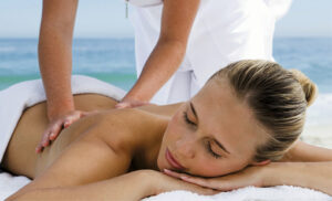 A woman getting a massage before dinner at a fine dining restaurant in Nassau, Bahamas.