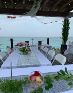 Tables set up for the reception of a Bahamas beach wedding.